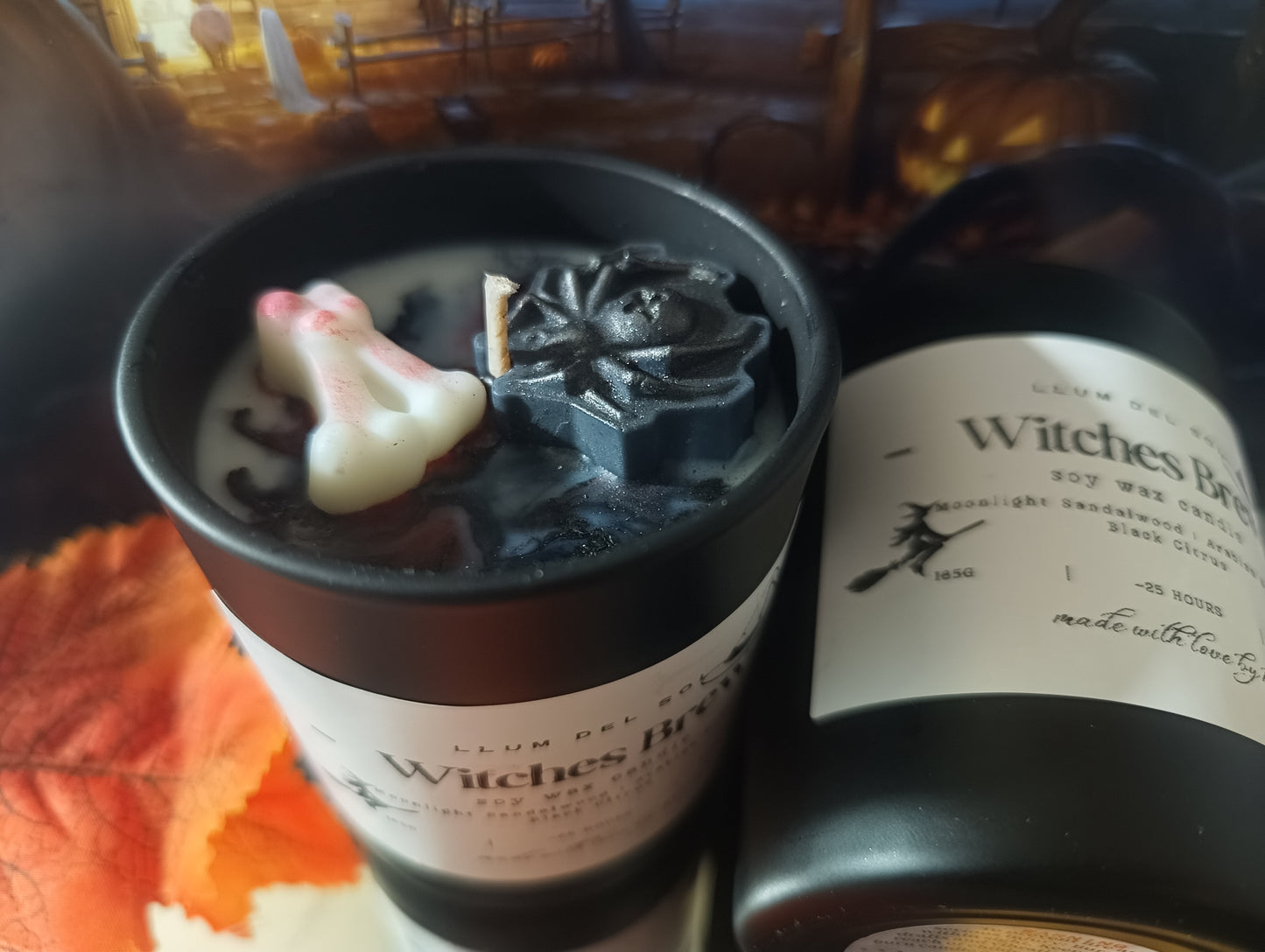 Two candles labeled 'Witches Brew' with decorative elements bones and spider